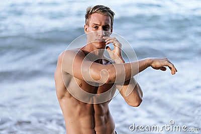 Close up portrait of sexy muscular naked man posing at beach Stock Photo