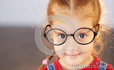 Close up portrait of smart little child girl in glasses Stock Photo
