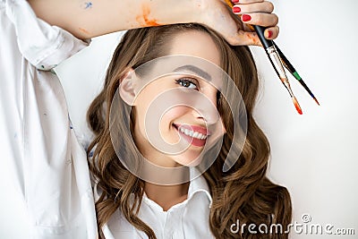 Close up portrait of smiling beautiful woman painter with paint Stock Photo