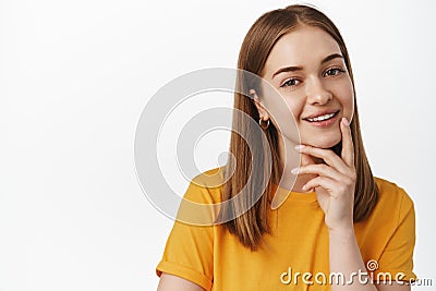 Close up portrait of smiling blond woman look intrigued, smiling thoughtful, interesting suggestion, standing pleased in Stock Photo