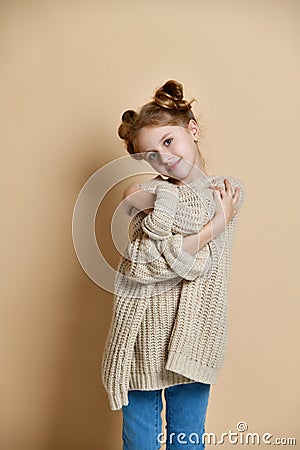 Close Up portrait smiling girl holding hugging herself isolated wall background. Stock Photo