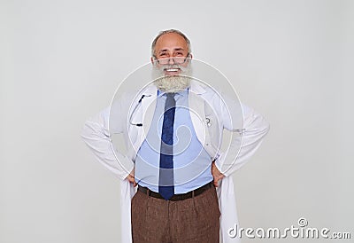 Close-up portrait of smiling mature bearded doctor with hands on Stock Photo