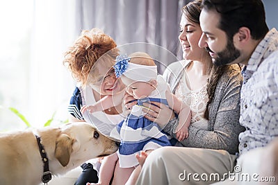 Close up portrait of three generations of women being close, grandmother, mother and baby daughter at home Stock Photo