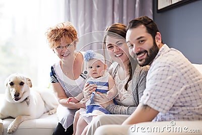 Close up portrait of three generations of women being close, grandmother, mother and baby daughter at home Stock Photo