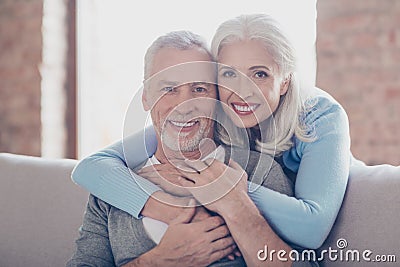 Close up portrait of two happy old married people, they are hugging and have perfect shiny white smiles Stock Photo