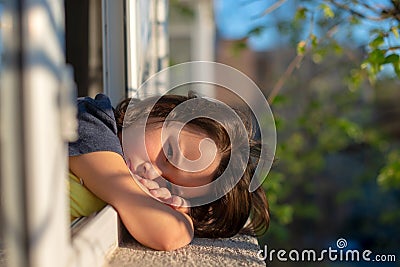 Close up of portrait upset little girl look far in window thinking about troubles, sad child Stock Photo