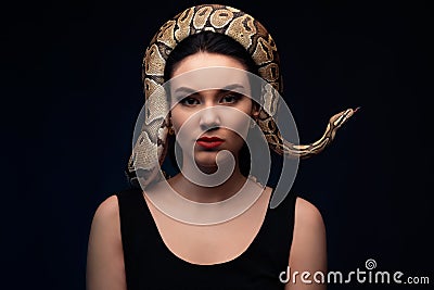Close up portrait of woman with snake on head Stock Photo