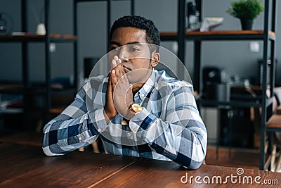 Close-up portrait of worried sad African American businessman cogitating thinking making important decision in modern Stock Photo