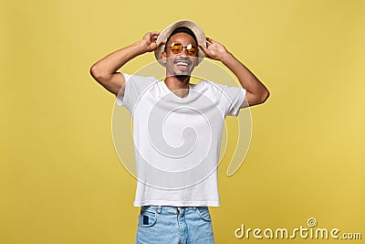Close up portrait of young afro american shocked tourist , holding his eyewear, wearing tourist outfit, hat, with wide Stock Photo