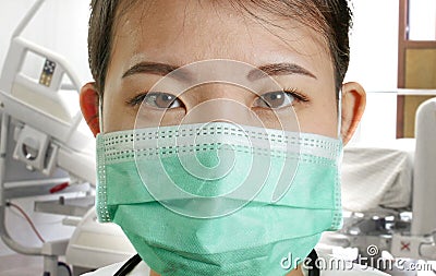 Close up portrait of young attractive and confident Asian Chinese medicine doctor woman in protective face mask and scrubs with Stock Photo