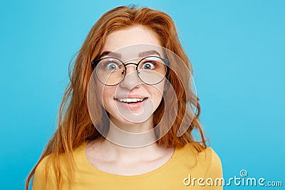 Close up Portrait young beautiful attractive redhair girl with eyeglass shocking with something. Blue Pastel Background Stock Photo