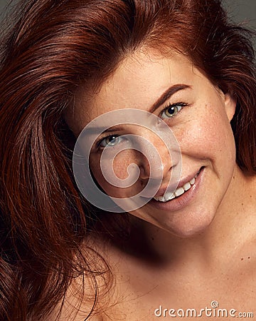 Close-up portrait of young beautiful red-haired woman with freckled face. Natural beauty. Glossy, perfect hair Stock Photo