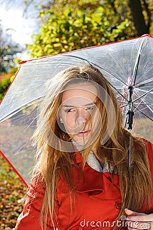 Close up portrait of young beautiful woman in Autumn park with red umbrella Stock Photo
