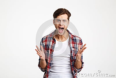 Close-up portrait of young emotional screaming man standing with Stock Photo