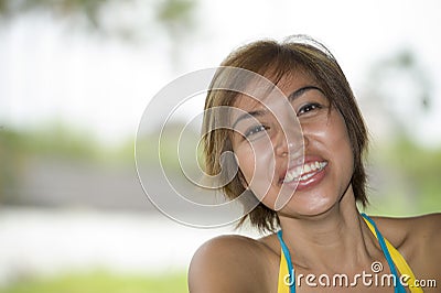 Close up portrait of young happy and beautiful expressive Asian woman laughing excited and nice in positive face expression Stock Photo