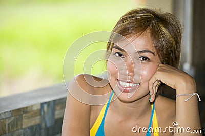 Close up portrait of young happy and beautiful expressive Asian woman smiling excited and nice in positive face expression Stock Photo