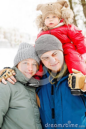 Close-up portrait of young happy family with one toddler in winter casual oufit Stock Photo
