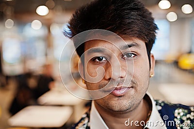 Close up portrait of young male indian freelancer in fast food cafe, handsome head of asian man wear in shirt at comfortable Stock Photo