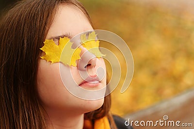 Close up portrait of young teenager girl relaxing and meditating outdoors in autumn park Stock Photo