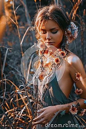 Close up portrait of young and tender woman on a feild at sunset Stock Photo