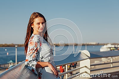 Close-up Portrait of a young woman with long blond hair, dressed in a blue elegant dress Stock Photo