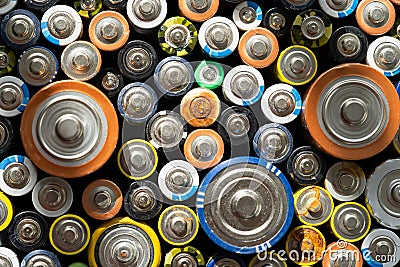 Close up of positive ends of discharged batteries of different sizes and formats. Used battery with corrosion and rust. Hazardous Stock Photo