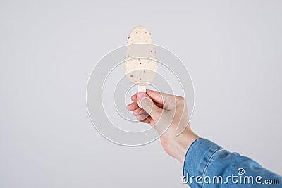 Close up pov first person cropped view photo of hand in denim clothes holding tasty yummy ice cream cover in white chocolate Stock Photo