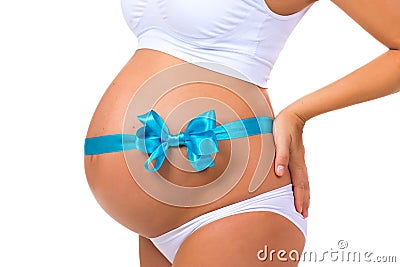 Close-up of pregnant belly with blue ribbon and bow. Concept of pregnancy. Newborn baby boy Stock Photo