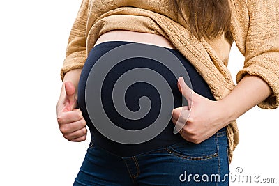 Close-up of pregnant belly with thumbs-up gesture Stock Photo