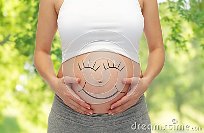 Close up of pregnant woman belly with smiley Stock Photo