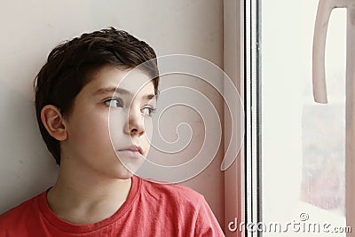 Close up preteen boy portrait look at the window Stock Photo
