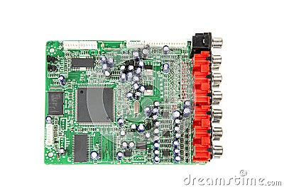 A close-up of the processor microchip surrounded by other electrical components on a green circuit board. Also on the board is a Stock Photo