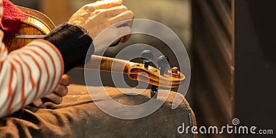 Close-up of a professional master artisan luthier working on the creation of a handmade violin Stock Photo