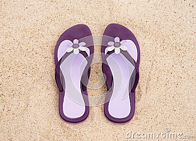 Close-up of purple flip-flops on the sand Stock Photo