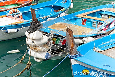 Close-up of quaint European style fishing boats with outboard motor moored in Cinque Terre traditional fishing village Editorial Stock Photo