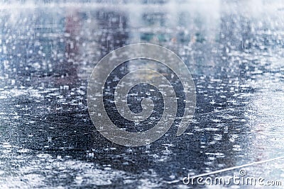 close up rain water drop falling in city street floor with the w Stock Photo