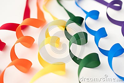 Rainbow of curled ribbons with white background Stock Photo