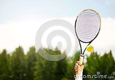 Close up of raised tennis racket Stock Photo