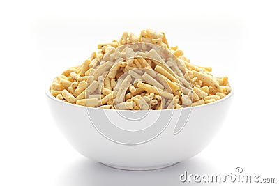 Close up of Ratlami Besan sev plane and salty Indian namkeen snacks on a ceramic white bowl. Stock Photo