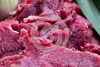 Close-up raw pieces of crude meat with garlic and onion Stock Photo