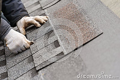 Workman install tile on roof of new house under construction Stock Photo