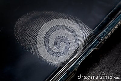 Close-up of realistic dirty glossy smart phone electronics device screen with fingerprint residue above in-screen reader Stock Photo