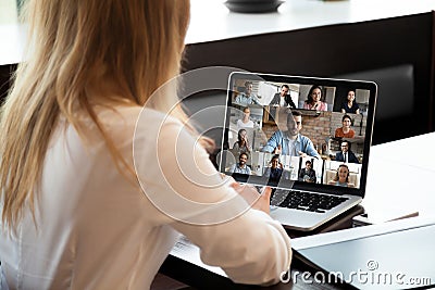 Close up rear view businesswoman talking with diverse colleagues online Stock Photo