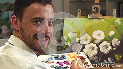 Rear view shot of a male artist working on a painting at his Art Studio Stock Photo