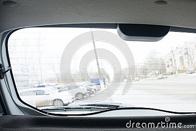 Close up of rear windshield wiper arm and blade on sun bleached blue vintage motor vehicle Stock Photo