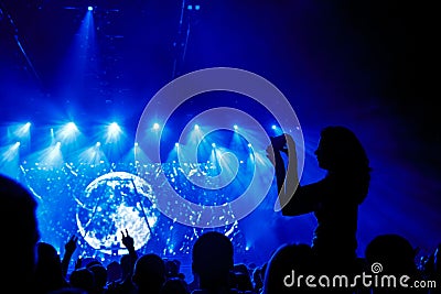 Close up of recording video with smartphone during a concert. Editorial Stock Photo