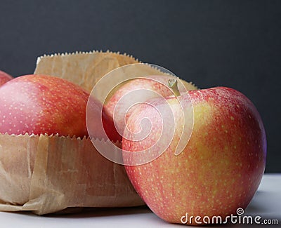 Close-up of red apples sitting on a brown paper bag Stock Photo