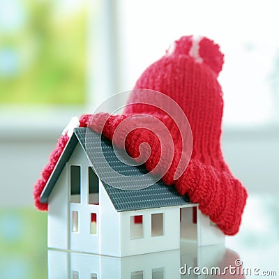Close up Red bobble hat on Cute Little House Stock Photo