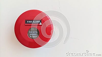 Close-up of red circular fire alarm with manual switch button to warn in case of fire emergency Stock Photo