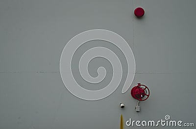 A close up of the red fire bell on the white wall Stock Photo